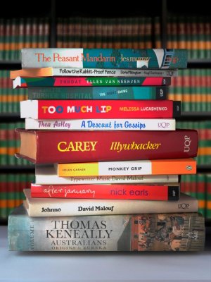 A stack of around a dozen Australian novels, with their spines showing.